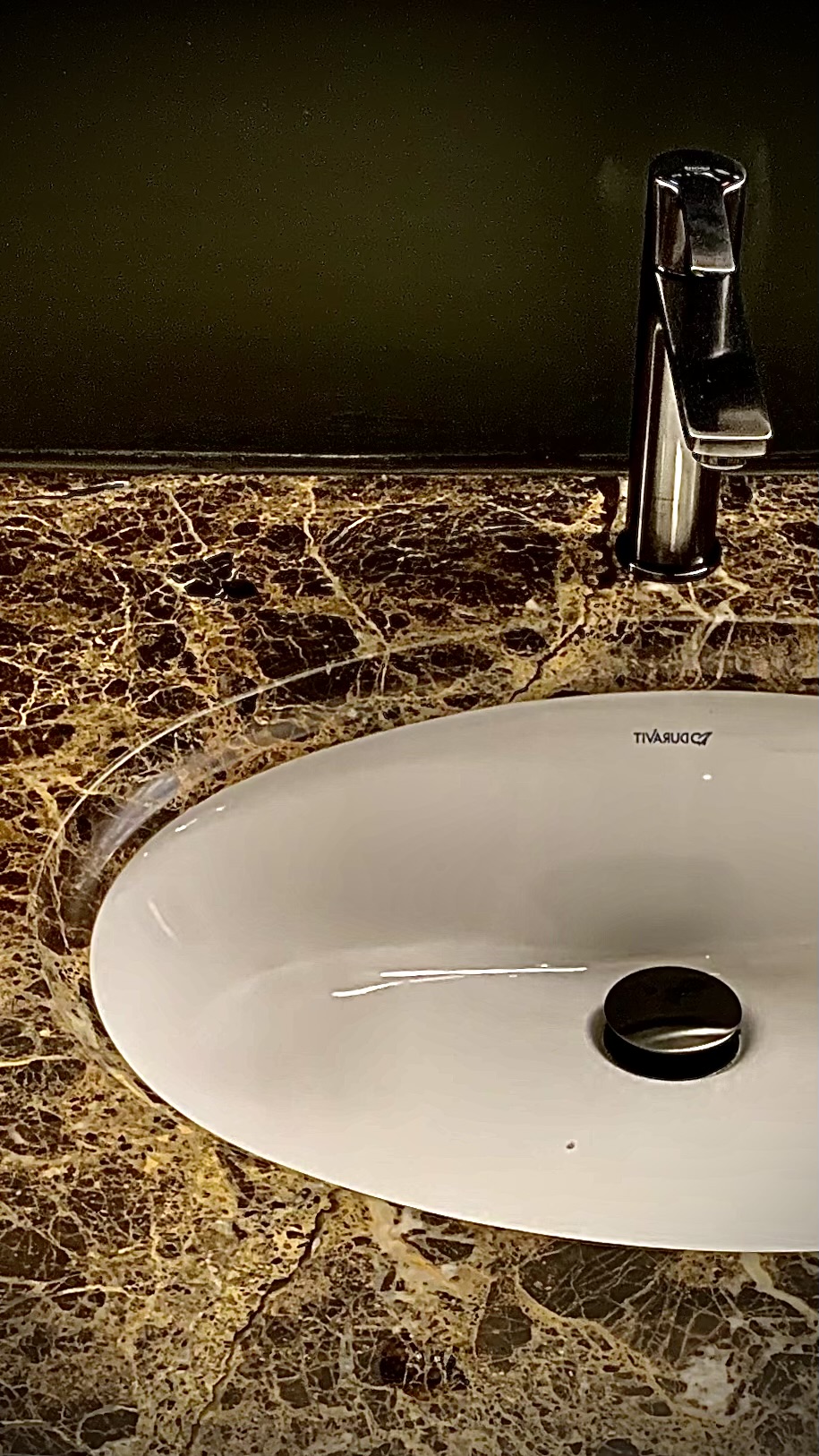Water beading on protective film over dark marble